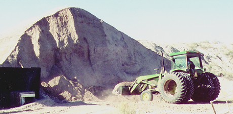 Photo of a loader at a stockpile of mineral